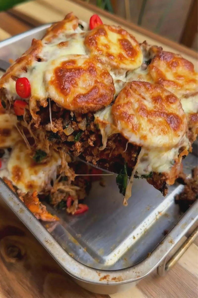 Golden layered sweet potato bake with savory ground beef, spinach and melted mozzarella