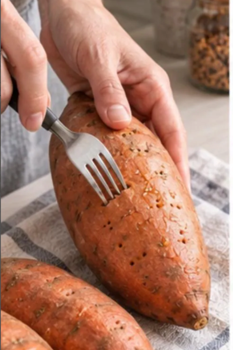 Whole scrubbed sweet potatoes prepared for roasting to make Mediterranean stuffed sweet potato boats.