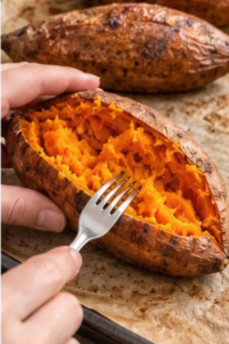 Roasted sweet potato sliced lengthwise and opened to create a boat for the Mediterranean chickpea filling.