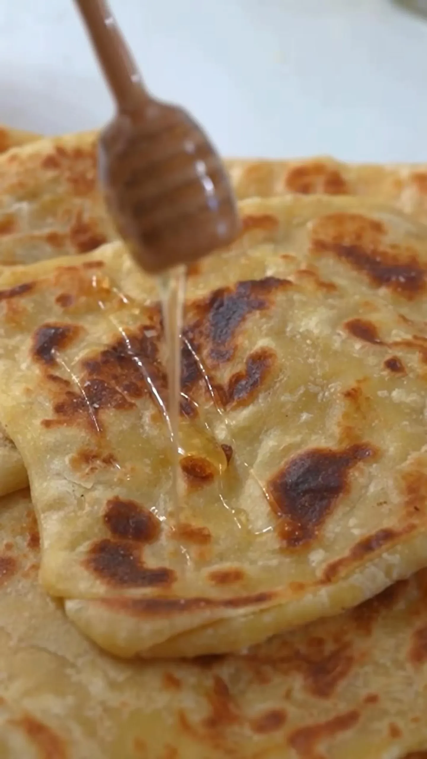 Flaky Moroccan msemen pancakes with golden-brown edges and soft layered centers