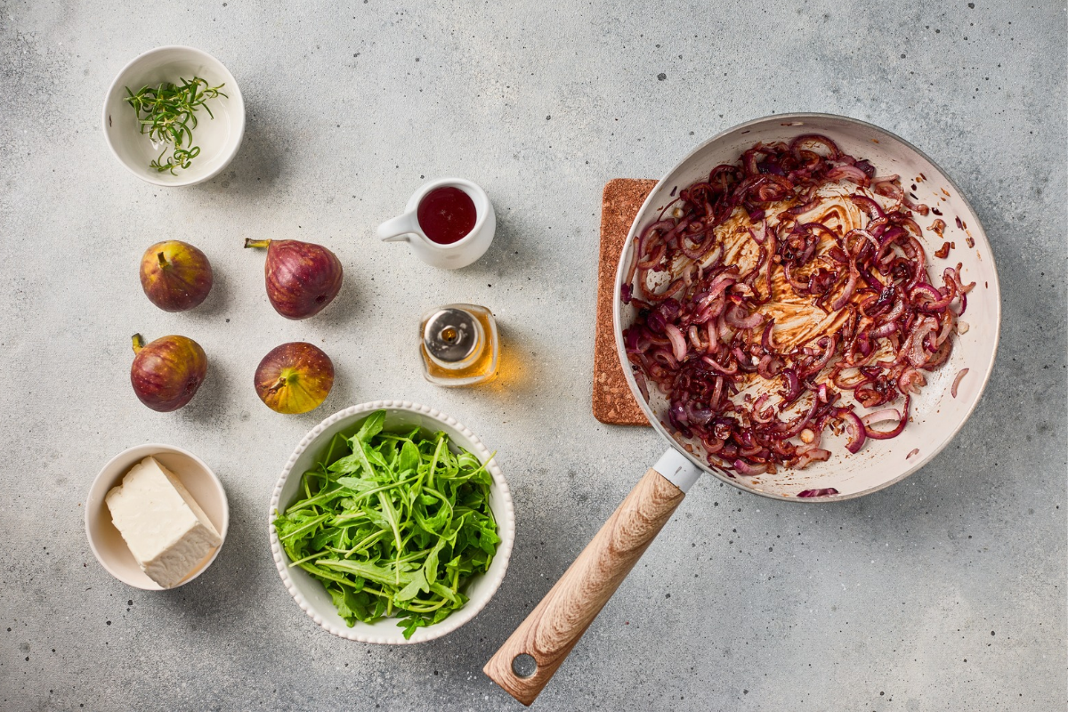  Glossy caramelized red onions cooked down in a skillet with balsamic sauce.