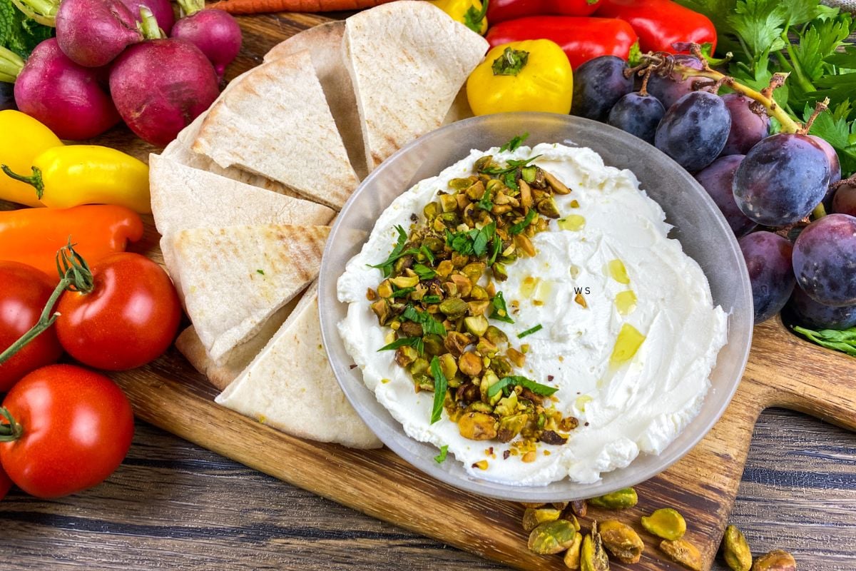 Mediterranean labneh veggie board with fresh vegetables and creamy labneh served as a colorful appetizer platter.