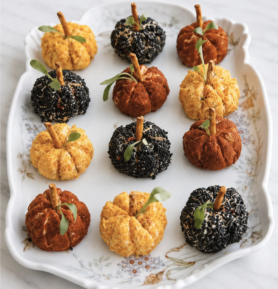 Mini pumpkin cheese balls arranged as a festive Fall appetizer, perfect for Autumn entertaining and a Thanksgiving appetizer table.