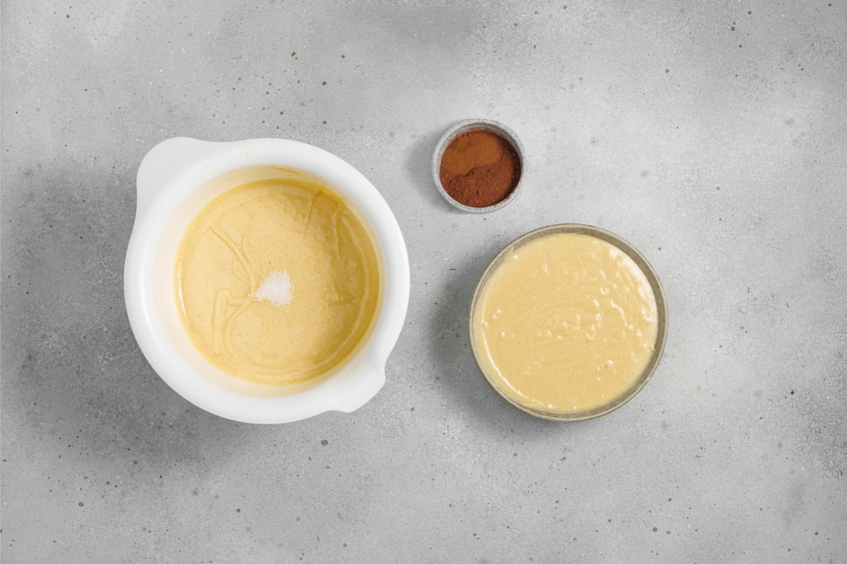Vanilla cake batter divided into two bowls with cocoa powder ready for mixing. #15: Chocolate and vanilla Bundt cake batters prepared in separate bowls