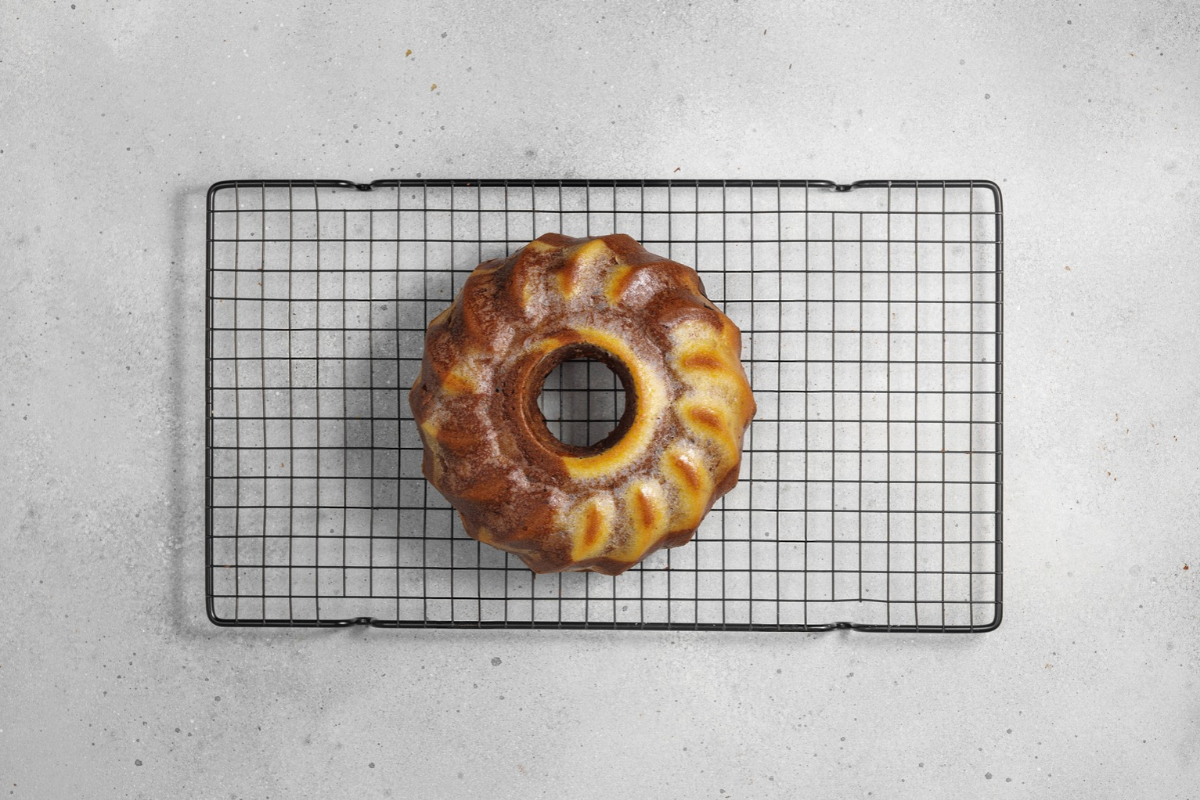 Freshly baked marble Bundt cake cooling on a wire rack
